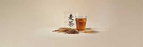 A bowl of mugicha (roasted barley tea) alongside the Japanese kanji characters ιΊ¦θΆ displayed on traditional packaging.
