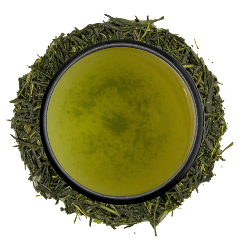 A cup of kabuse sencha seen from above, ringed by shaded sencha leaves on a white background